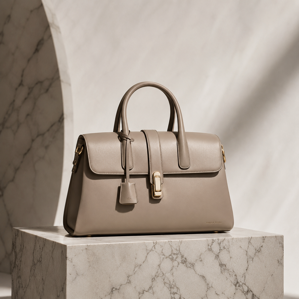 Taupe leather handbag on marble platform